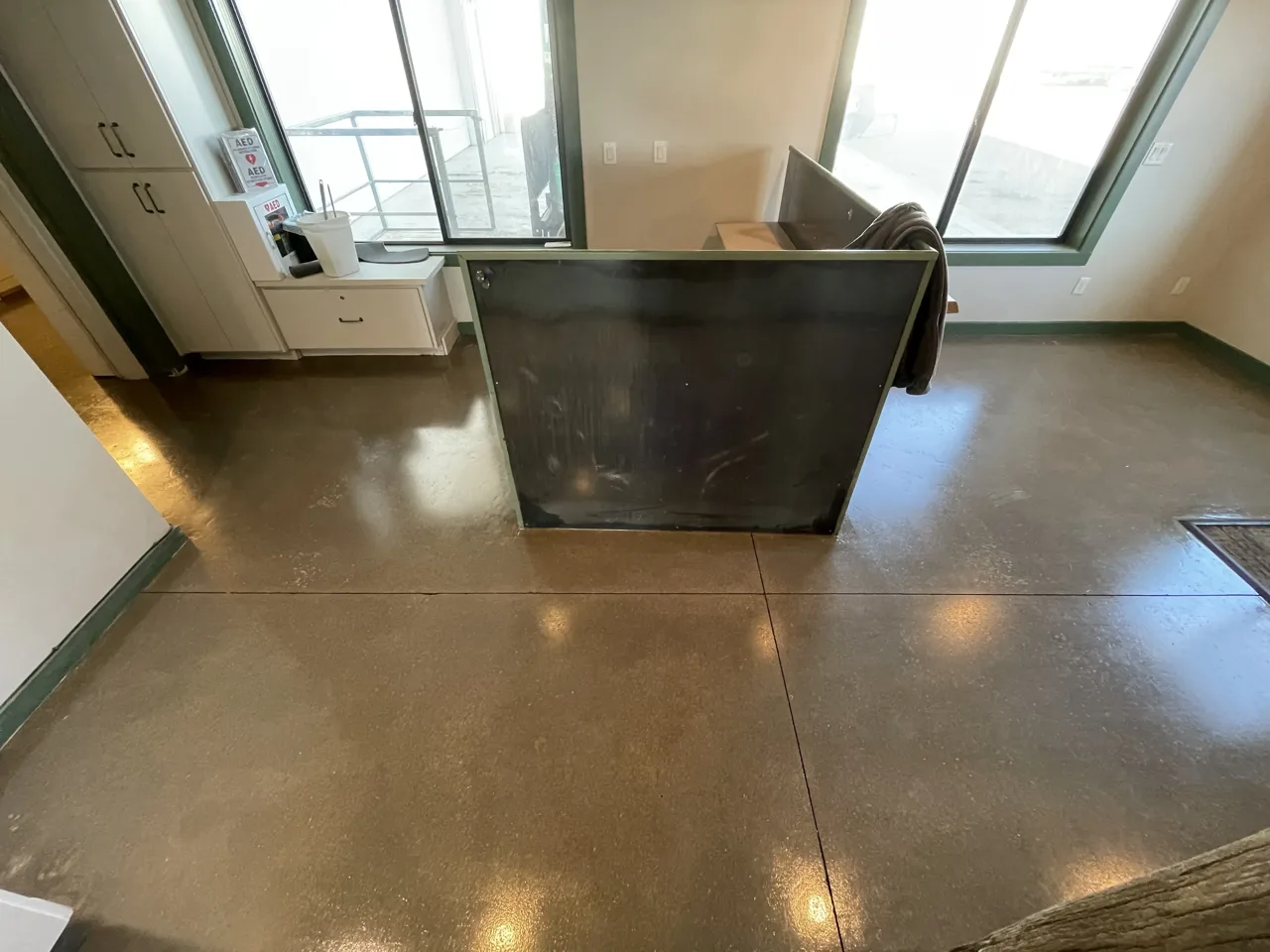 Brown-toned concrete floor around a dark interior counter