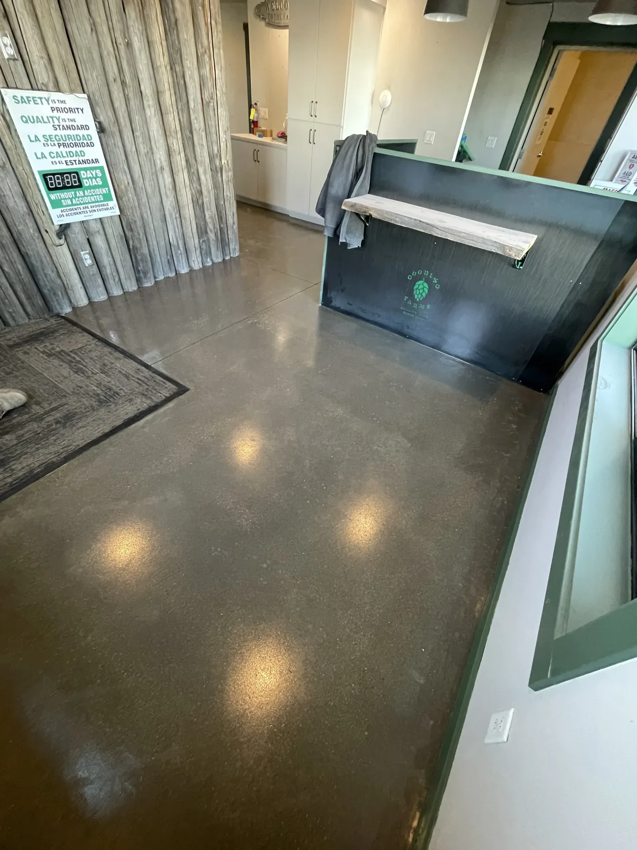 Brown-toned interior concrete floor beside a dark counter
