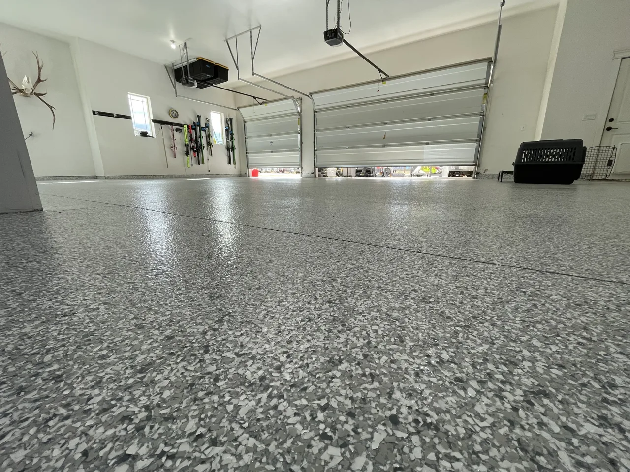 Gray flake garage floor viewed toward the overhead doors