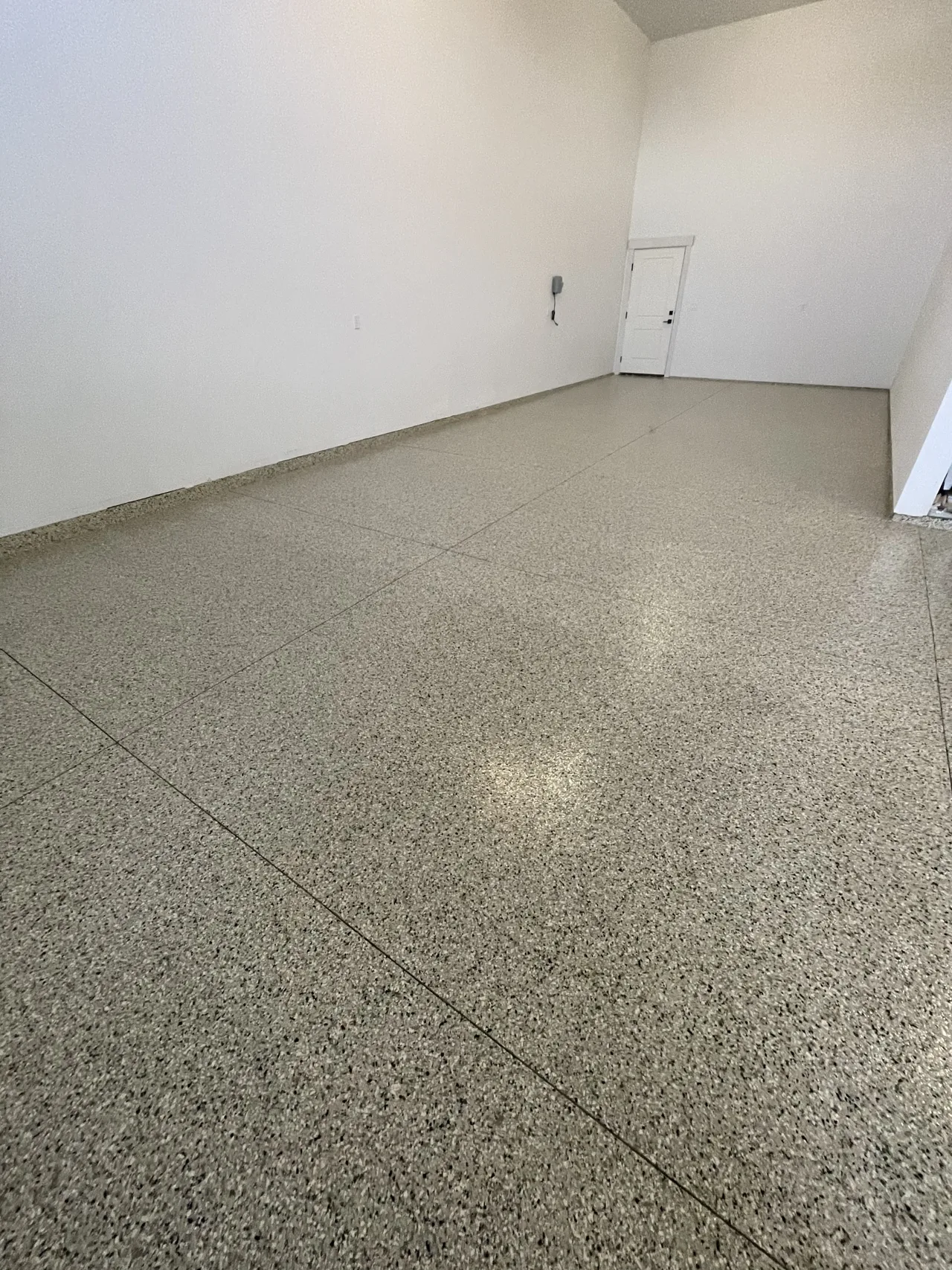 Gray flake floor in the corner of a garage
