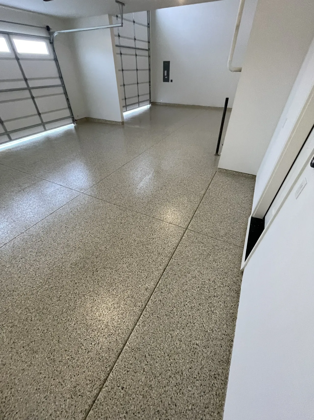 Gray flake floor viewed down a garage bay