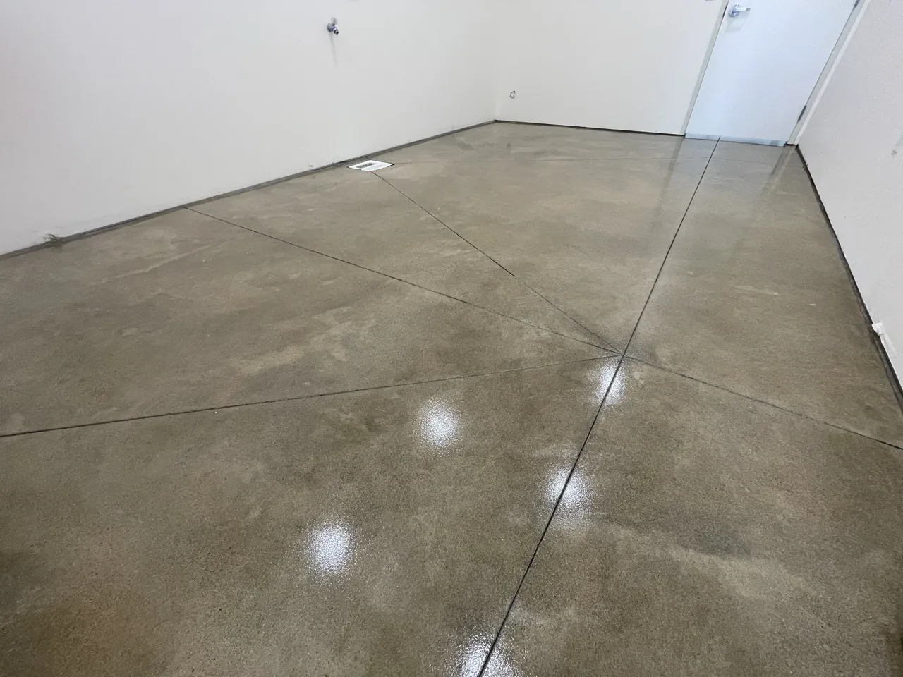 Mottled brown concrete floor in an empty interior room