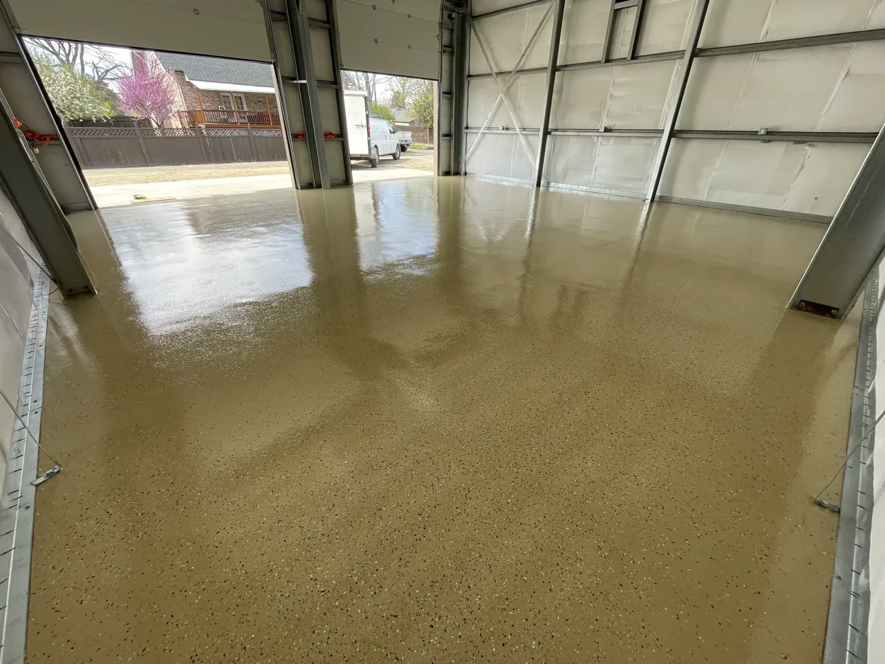 Tan flake shop floor beside a large overhead door